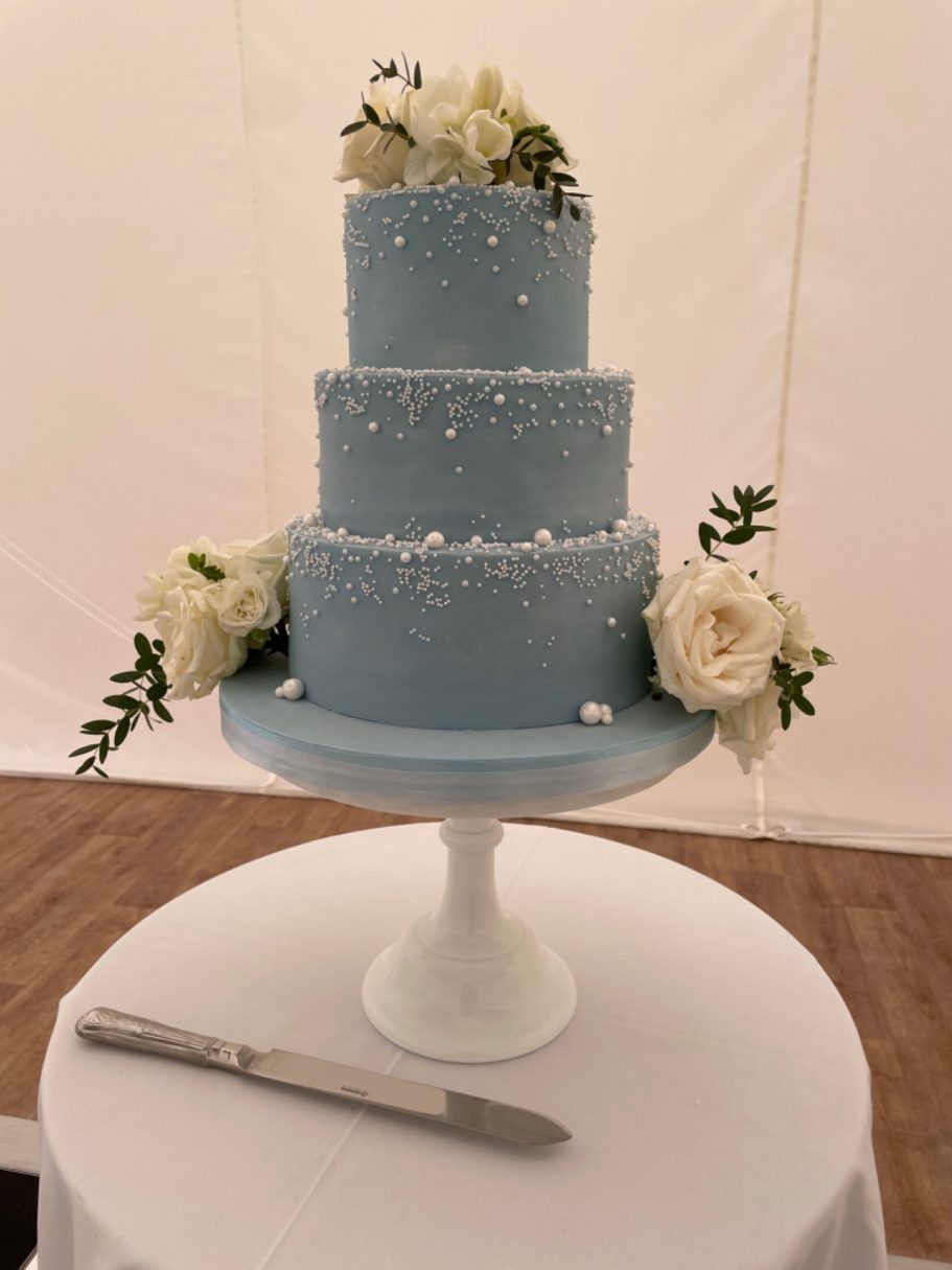 Stunningly elegant cascading pearl decorated baby blue three tier wedding cake Stunningly elegant cascading pearl decorated baby blue three tier wedding cake
