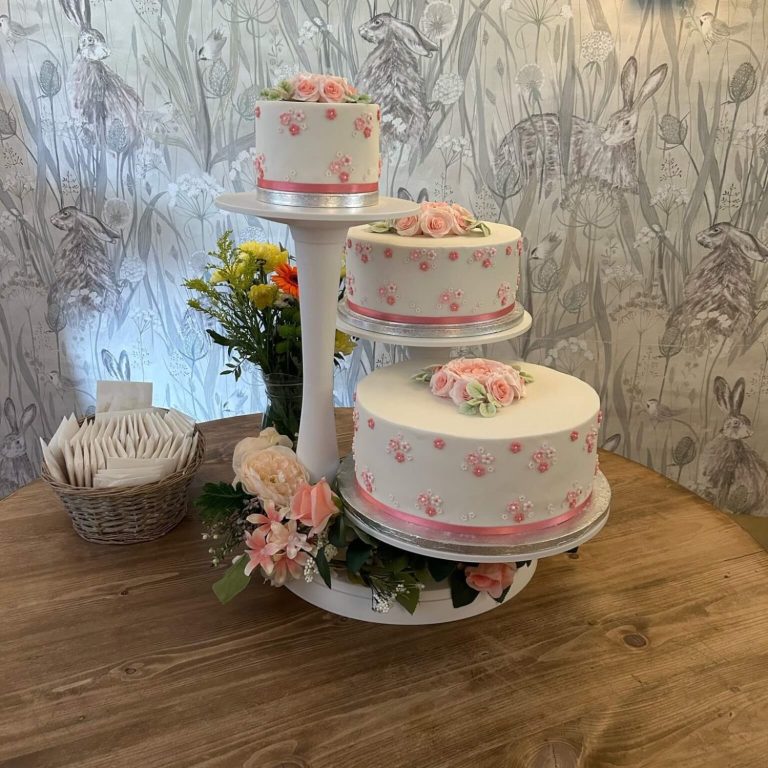 Happy wedding couple cutting wedding cake